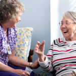 A woman caring for a an elderly women